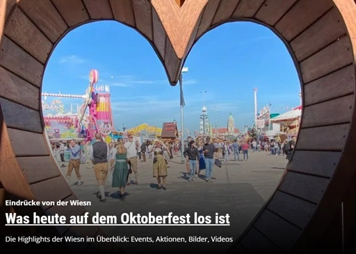 a group of people outside of a wooden window in shape of a heart at the munich octoberfest